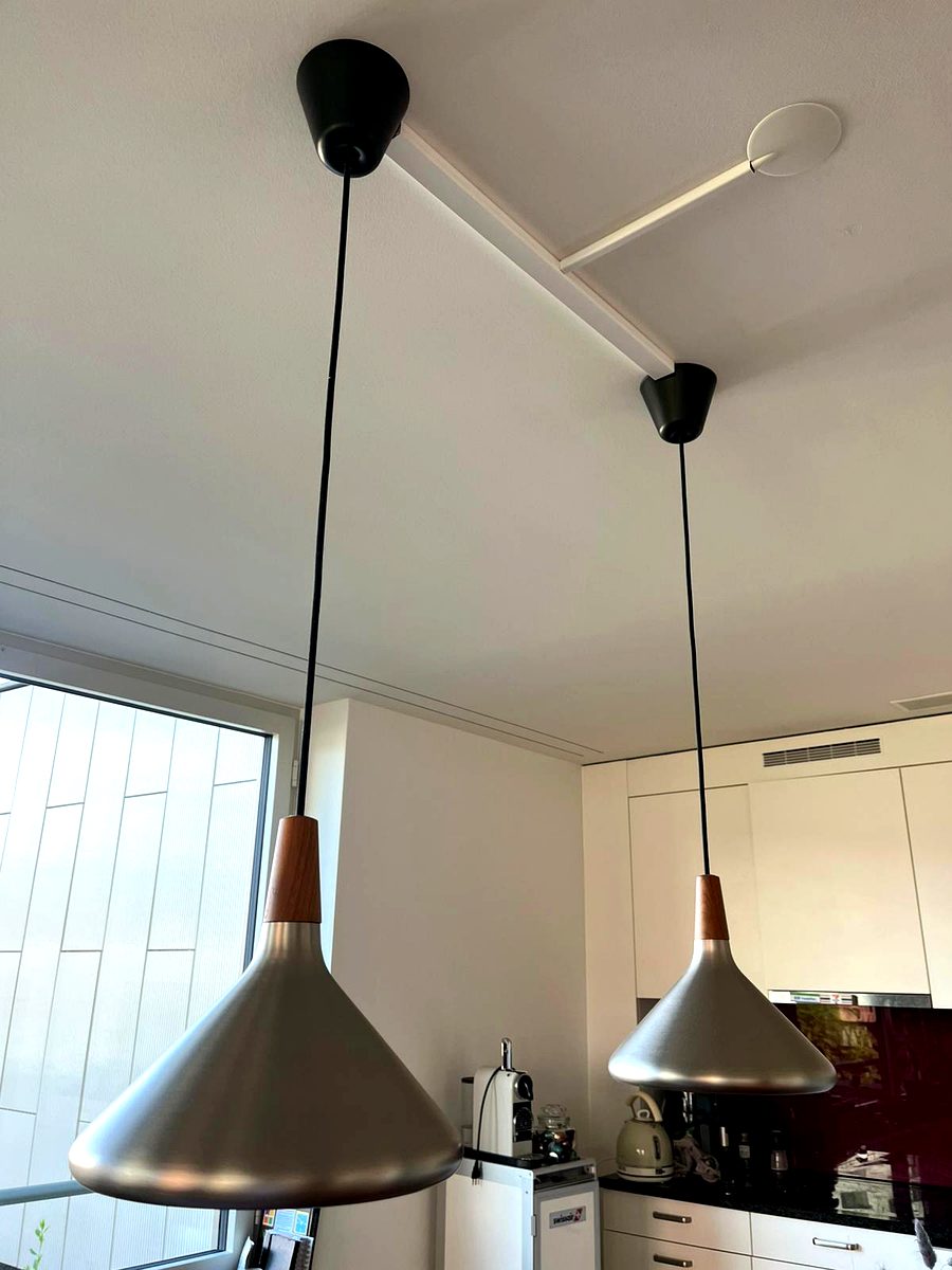 Two modern pendant lamps installed above kitchen counter